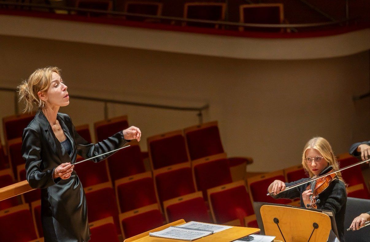 Hannah playing beside the conductor